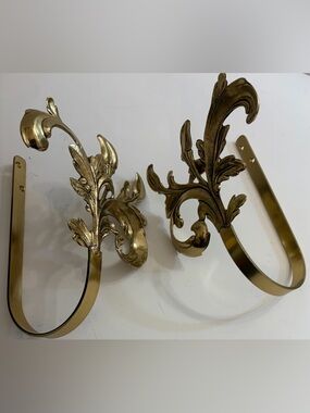 Vintage brass curtain ties featuring ornate scrolls and acanthus leaf design